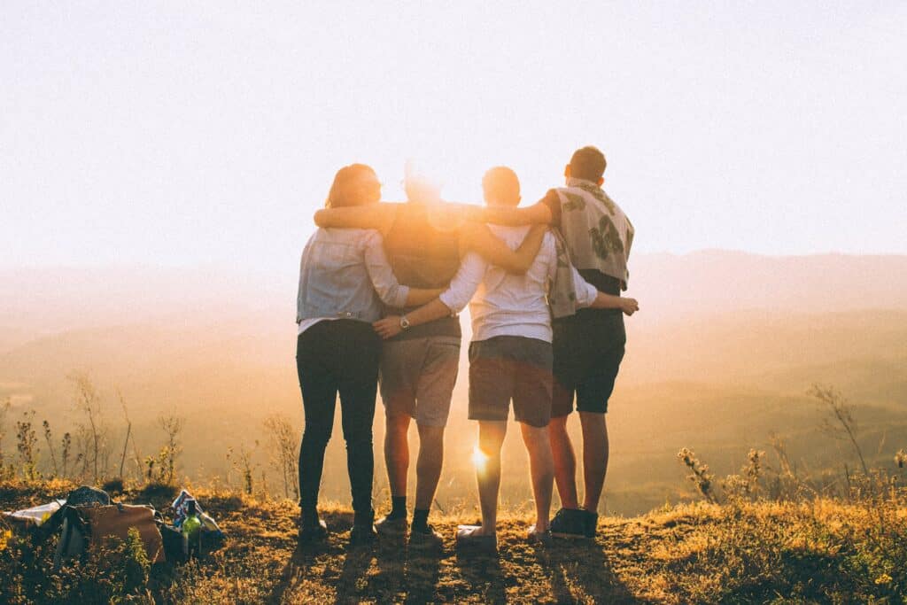 four friends looking at the sunset